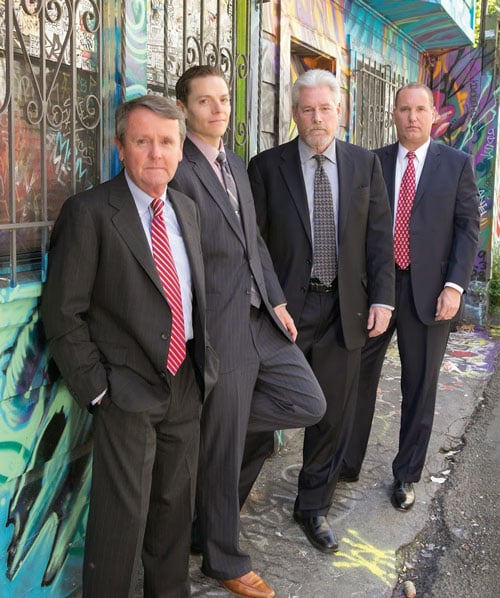 Photo of the firm's attorneys in front of a bright mural